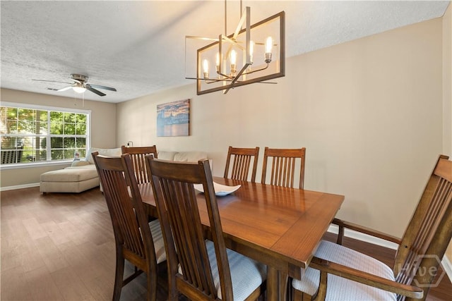 310 Mapmaker Ln, Savannah, GA 31410 - dining room with wood finished floors, a textured ceiling, ceiling fan, and a chandelier