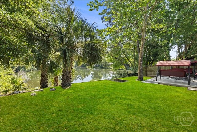 310 Mapmaker Ln, Savannah, GA 31410 - view of yard featuring a water view, a hot tub, and a patio area