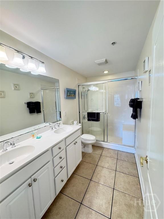 404 Butler Ave Unit 612, Tybee Island, GA 31328 - bathroom featuring tile patterned floors, double vanity, and a shower stall