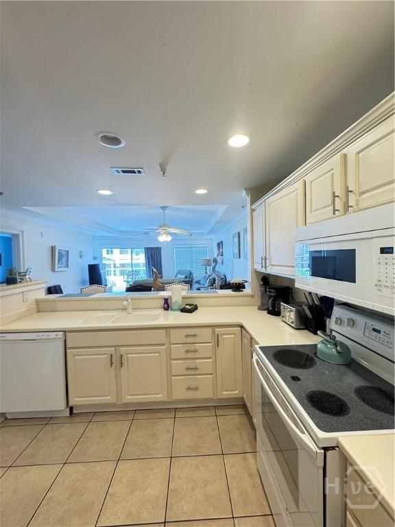 404 Butler Ave Unit 612, Tybee Island, GA 31328 - kitchen featuring white appliances, open floor plan, white cabinets, light tile patterned floors, and light countertops