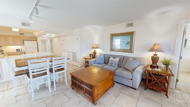 1609 Strand Ave Unit 306, Tybee Island, GA 31328 - living room with track lighting and light tile patterned flooring