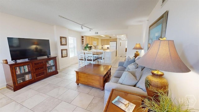 1609 Strand Ave Unit 306, Tybee Island, GA 31328 - living room featuring track lighting and light tile patterned floors