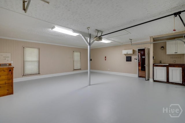 611 Benton Dr, Pooler, GA 31322 - garage featuring a garage door opener and wood walls