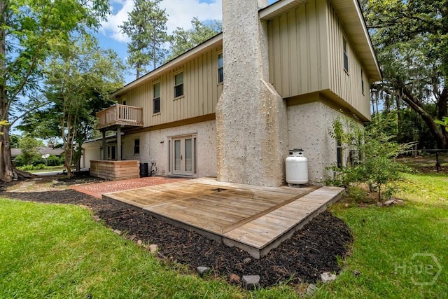 611 Benton Dr, Pooler, GA 31322 - rear view of house with french doors, board and batten siding, a wooden deck, a lawn, and a chimney