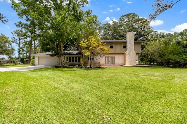 611 Benton Dr, Pooler, GA 31322 - view of front of home featuring french doors, driveway, a garage, a chimney, and a front lawn