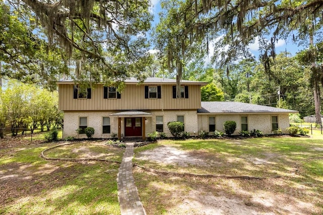 611 Benton Dr, Pooler, GA 31322 - view of front of house with a front yard, brick siding, and view of wooded area