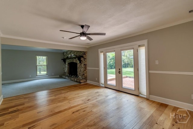 611 Benton Dr, Pooler, GA 31322 - unfurnished living room featuring a ceiling fan, wood-type flooring, french doors, a brick fireplace, and crown molding