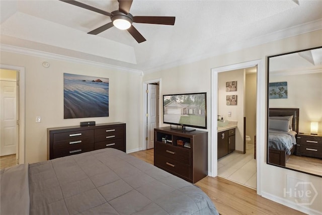 226 Silver Brook Cir, Pooler, GA 31322 - bedroom featuring light wood-type flooring, crown molding, a raised ceiling, ensuite bath, and ceiling fan