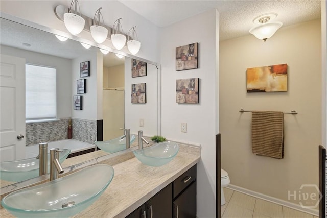 226 Silver Brook Cir, Pooler, GA 31322 - bathroom featuring a bath, double vanity, a textured ceiling, and tile patterned floors