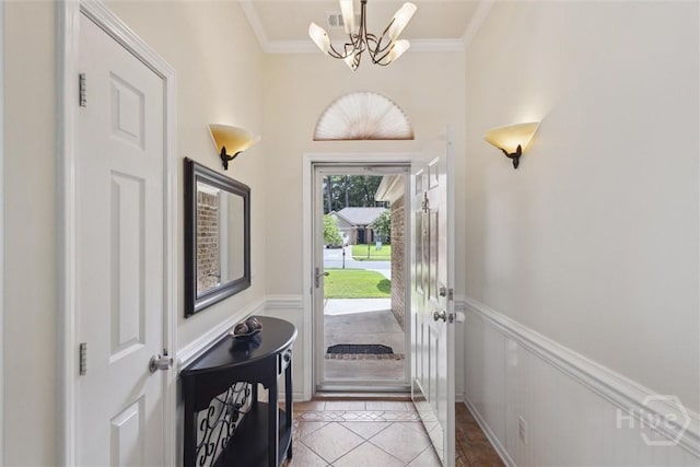 226 Silver Brook Cir, Pooler, GA 31322 - foyer entrance featuring a chandelier, crown molding, a wainscoted wall, and a decorative wall