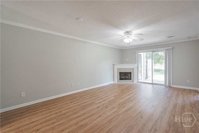 76 Al Henderson Blvd Unit G-4, Savannah, GA 31419 - unfurnished living room featuring a ceiling fan, a textured ceiling, light wood-style flooring, a tile fireplace, and crown molding