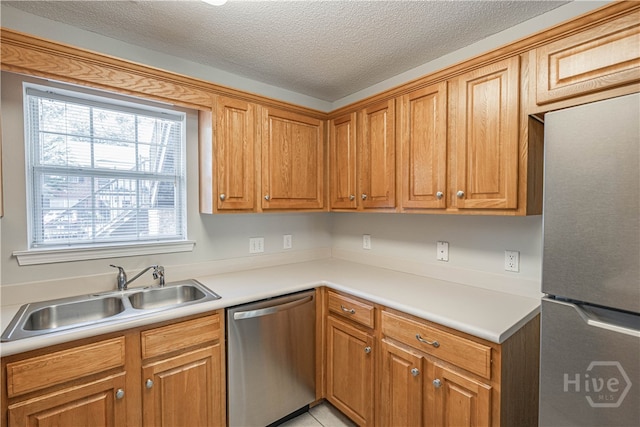 76 Al Henderson Blvd Unit G-4, Savannah, GA 31419 - kitchen featuring stainless steel appliances, light countertops, brown cabinetry, and a textured ceiling