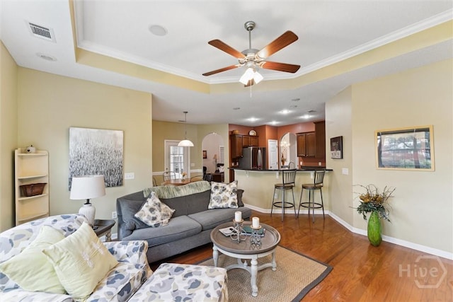 7 River Rock Rd, Savannah, GA 31419 - living room with a raised ceiling, a ceiling fan, dark wood-style flooring, and crown molding