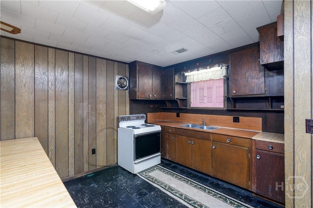 401 E Smith St, Claxton, GA 30417 - kitchen with white electric range oven, open shelves, dark flooring, wooden walls, and light countertops