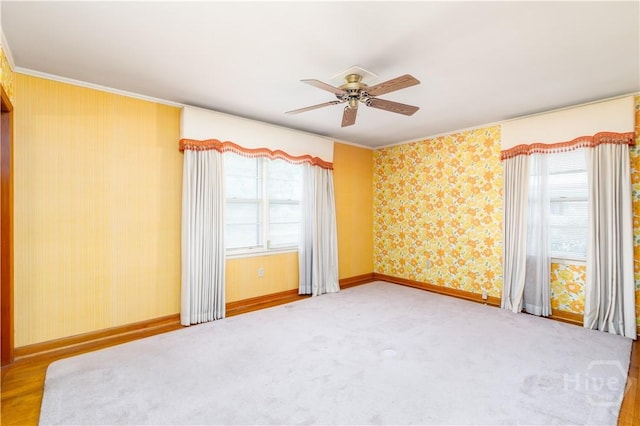 401 E Smith St, Claxton, GA 30417 - empty room with a ceiling fan, ornamental molding, healthy amount of natural light, wallpapered walls, and carpet flooring