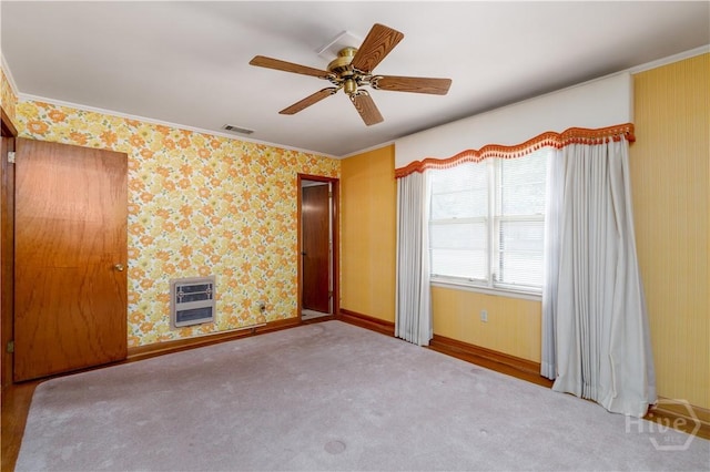 401 E Smith St, Claxton, GA 30417 - spare room featuring heating unit, crown molding, ceiling fan, and carpet flooring