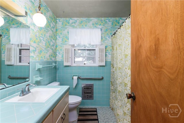 401 E Smith St, Claxton, GA 30417 - bathroom with wallpapered walls, vanity, heating unit, tile walls, and a shower with curtain