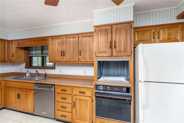 401 E Smith St, Claxton, GA 30417 - kitchen with freestanding refrigerator, wallpapered walls, oven, stainless steel dishwasher, and ornamental molding