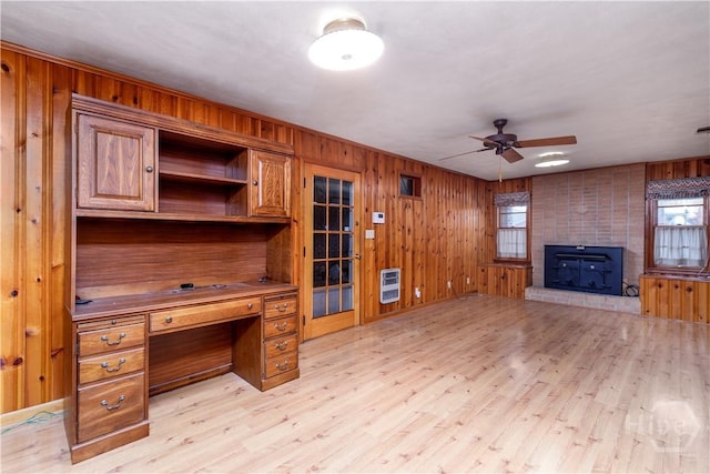 401 E Smith St, Claxton, GA 30417 - unfurnished office with heating unit, a ceiling fan, wooden walls, light wood-type flooring, and a large fireplace
