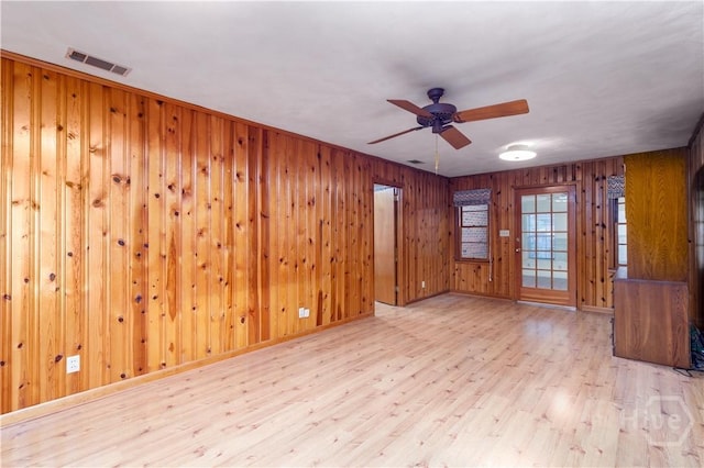 401 E Smith St, Claxton, GA 30417 - empty room featuring wood finished floors, ceiling fan, and wood walls