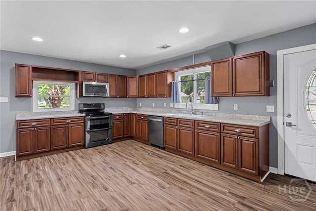 2 Brandle Cv, Savannah, GA 31405 - kitchen featuring appliances with stainless steel finishes, light wood finished floors, light countertops, recessed lighting, and brown cabinets