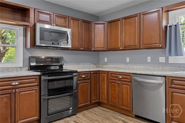 2 Brandle Cv, Savannah, GA 31405 - kitchen with stainless steel appliances, light countertops, and brown cabinetry