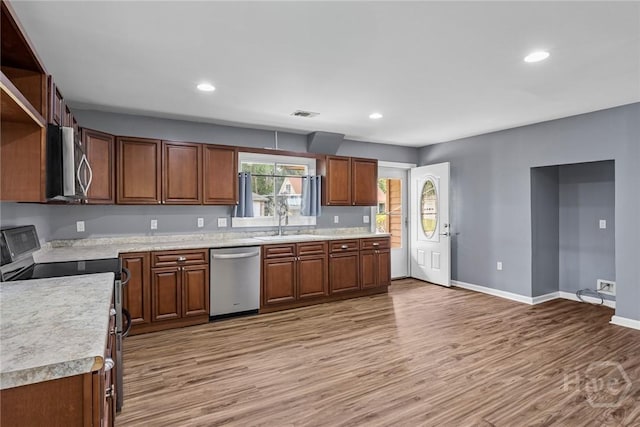 2 Brandle Cv, Savannah, GA 31405 - kitchen featuring stainless steel appliances, light countertops, light wood-type flooring, recessed lighting, and brown cabinetry