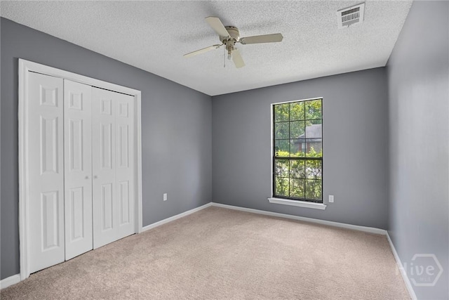 2 Brandle Cv, Savannah, GA 31405 - unfurnished bedroom featuring carpet floors, a closet, a textured ceiling, and a ceiling fan