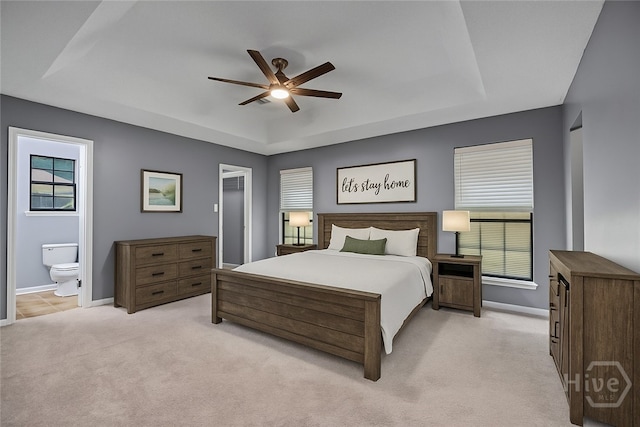 2 Brandle Cv, Savannah, GA 31405 - bedroom with a tray ceiling, light carpet, ensuite bathroom, and ceiling fan