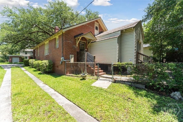 1405 E 51st St, Savannah, GA 31404 - view of front of house featuring a front lawn and brick siding