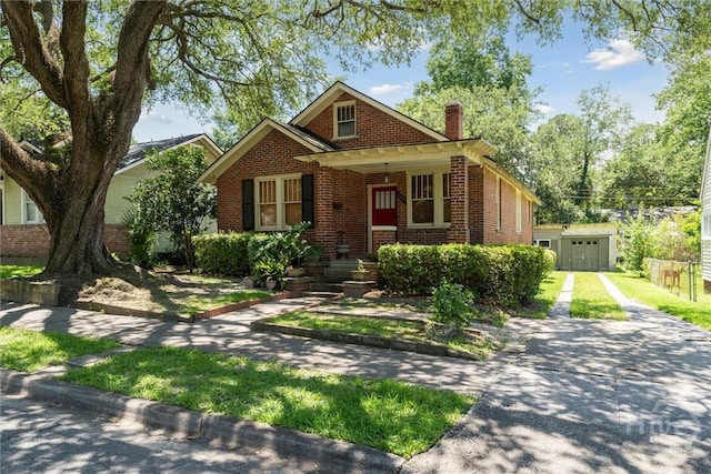 1405 E 51st St, Savannah, GA 31404 - view of front facade featuring brick siding, a chimney, a porch, and driveway