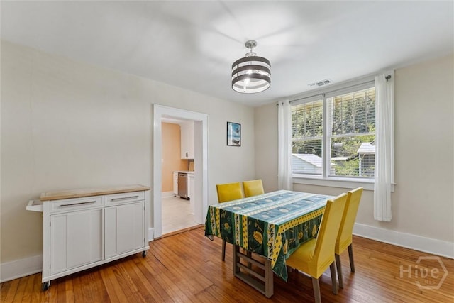 1405 E 51st St, Savannah, GA 31404 - dining room with light wood-style flooring and a chandelier