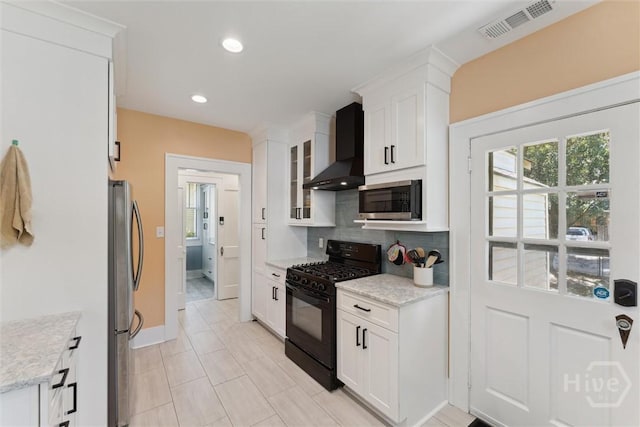 1405 E 51st St, Savannah, GA 31404 - kitchen with stainless steel appliances, wall chimney range hood, white cabinets, tasteful backsplash, and glass insert cabinets
