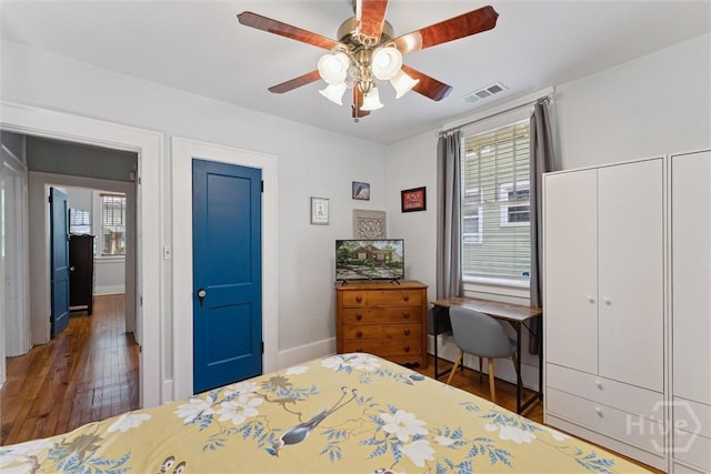 1405 E 51st St, Savannah, GA 31404 - bedroom with multiple windows, wood finished floors, ceiling fan, and multiple closets