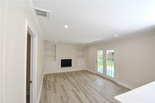 1003 Lora St, Savannah, GA 31410 - unfurnished living room with light wood-style flooring, recessed lighting, a fireplace, built in features, and crown molding