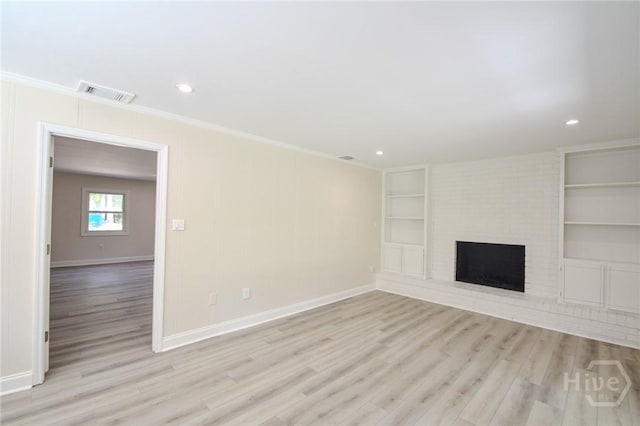 1003 Lora St, Savannah, GA 31410 - unfurnished living room with built in features, light wood finished floors, crown molding, a fireplace, and recessed lighting