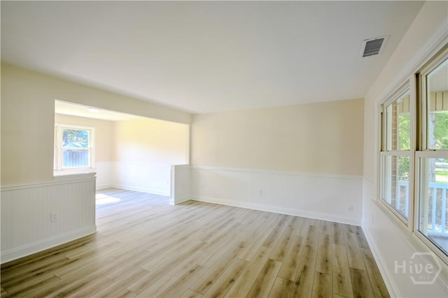 1003 Lora St, Savannah, GA 31410 - unfurnished room featuring light wood-style flooring and wainscoting
