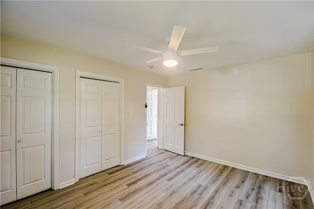 1003 Lora St, Savannah, GA 31410 - unfurnished bedroom featuring light wood finished floors, two closets, and a ceiling fan