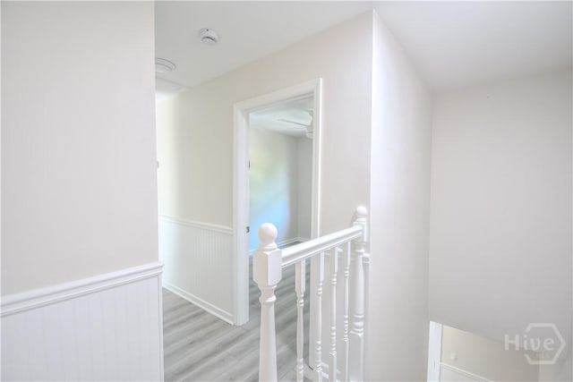 1003 Lora St, Savannah, GA 31410 - hall with an upstairs landing, light wood-style flooring, and a wainscoted wall