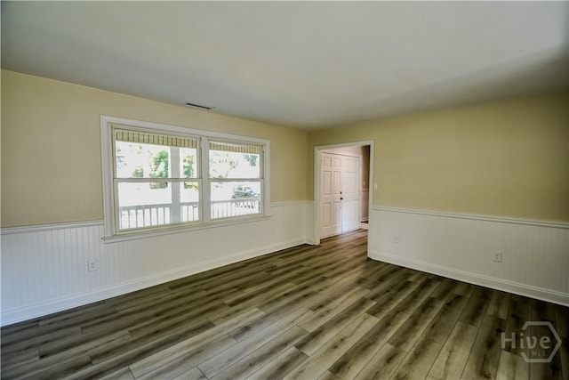 1003 Lora St, Savannah, GA 31410 - unfurnished room featuring a wainscoted wall and dark wood-style floors