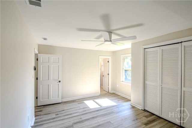 1003 Lora St, Savannah, GA 31410 - unfurnished bedroom with light wood finished floors, a closet, and a ceiling fan