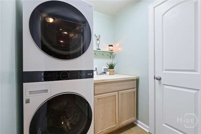 28 Cross Gate Ct, Pooler, GA 31322 - laundry area with stacked washer and clothes dryer, cabinet space, and light wood-style floors
