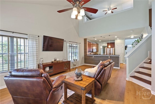 28 Cross Gate Ct, Pooler, GA 31322 - living area featuring a ceiling fan, light wood finished floors, a towering ceiling, and stairs