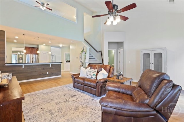 28 Cross Gate Ct, Pooler, GA 31322 - living area featuring a ceiling fan, stairs, a towering ceiling, light wood-style flooring, and french doors