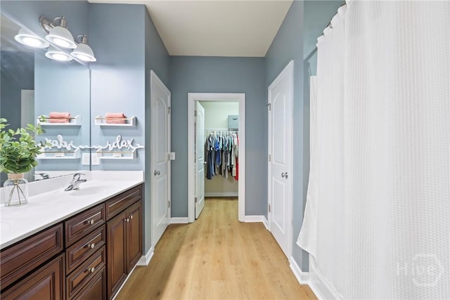 28 Cross Gate Ct, Pooler, GA 31322 - bathroom featuring wood finished floors, vanity, a walk in closet, and a shower with curtain