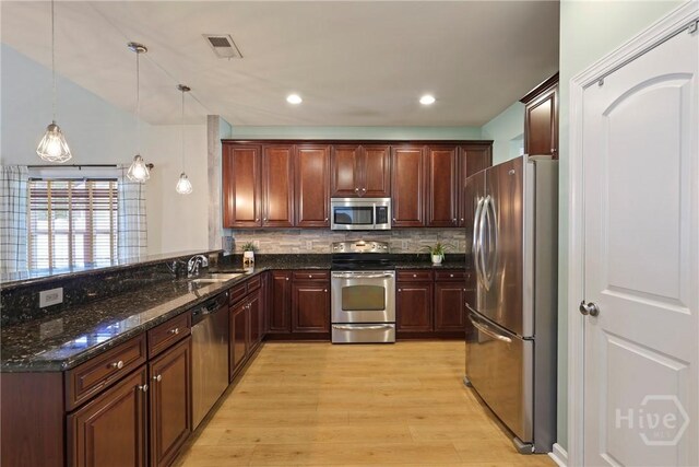 28 Cross Gate Ct, Pooler, GA 31322 - kitchen featuring stainless steel appliances, light wood-style floors, a peninsula, decorative backsplash, and dark stone counters