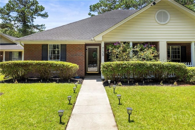 135 Trellis Way, Savannah, GA 31419 - view of front of house featuring a front yard, brick siding, and roof with shingles