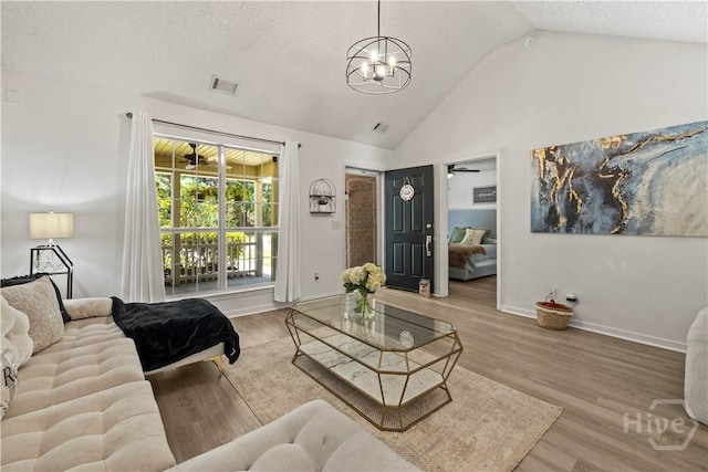 135 Trellis Way, Savannah, GA 31419 - living room with a chandelier, wood finished floors, a textured ceiling, high vaulted ceiling, and a ceiling fan