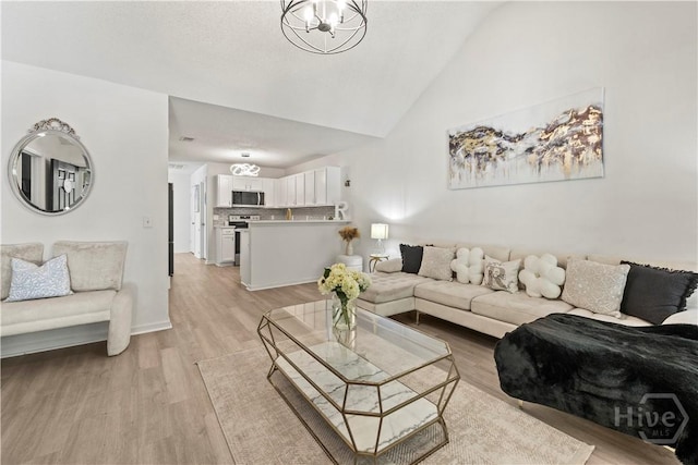 135 Trellis Way, Savannah, GA 31419 - living room featuring light wood-type flooring, a chandelier, and high vaulted ceiling