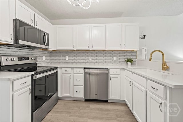 135 Trellis Way, Savannah, GA 31419 - kitchen featuring stainless steel appliances, light countertops, a peninsula, and white cabinets